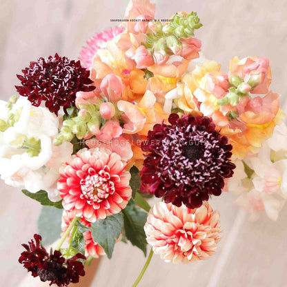 Photo of a flower bouquet with Snapdragon Rocket Bronze, fire and ice dahlias, black knight scabiosa and potomac appleblossom snapdragons. 